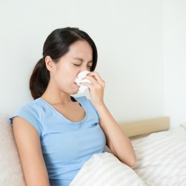 Woman feeling sick on the bed